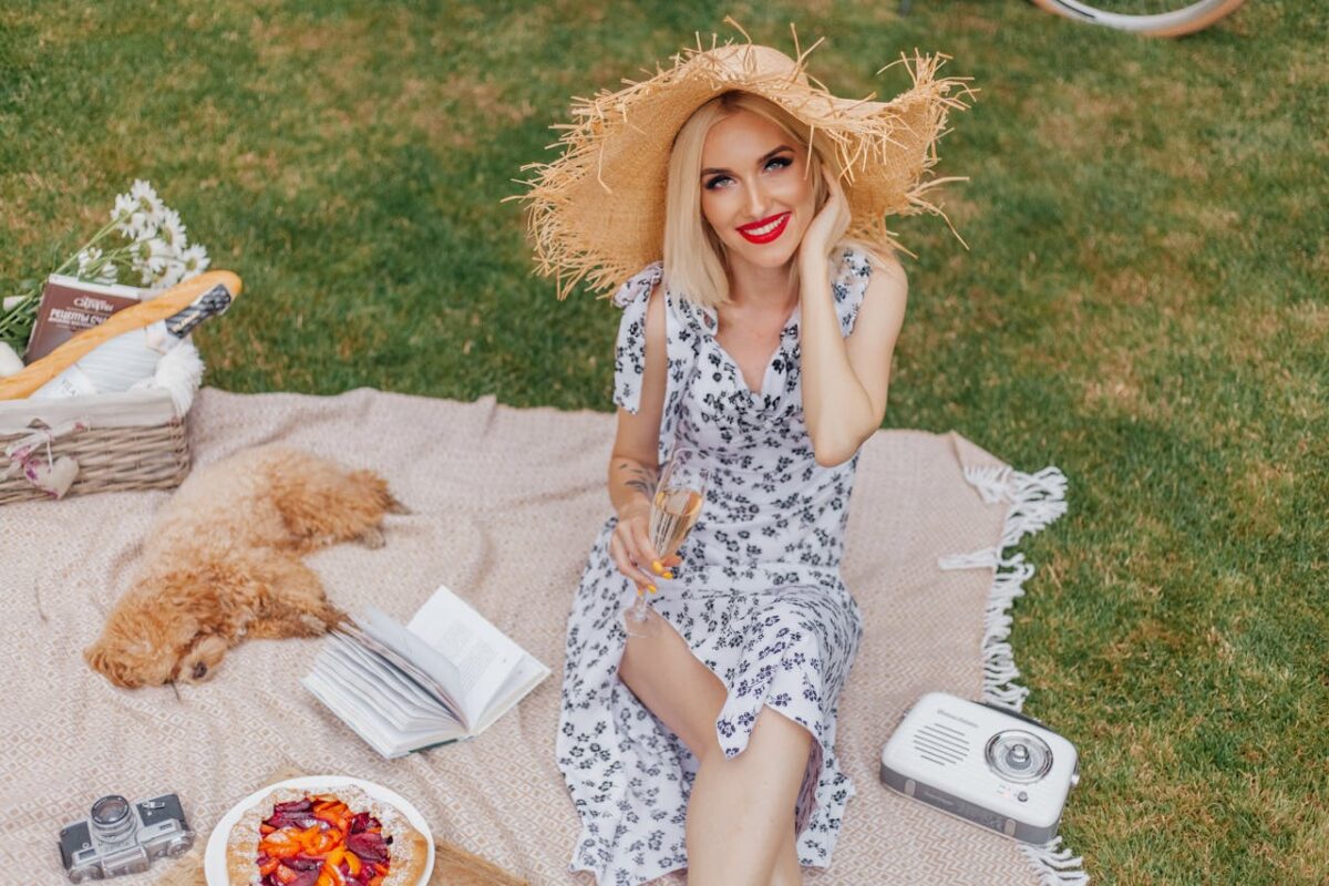 Woman in sundress enjoying a picnic with her dog in a Moroccan garden. Stylish and relaxed vibe.